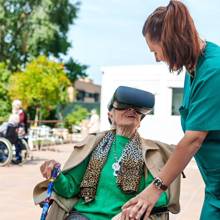 senior-woman-experiencing virtual reality in nursing home courtyard.